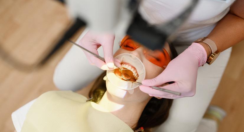 Female dentist and patient with opened mouth in clinic, top view, stomatology. Doctor in uniform, medical worker, medicine and health, professional teeth care, dentistry